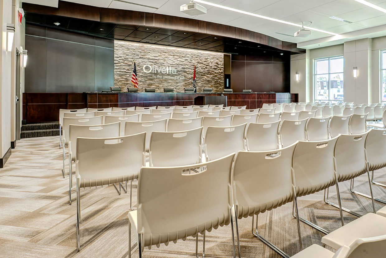 Wedge sconces provide sophisticated architectural lighting for a modern government meeting room 