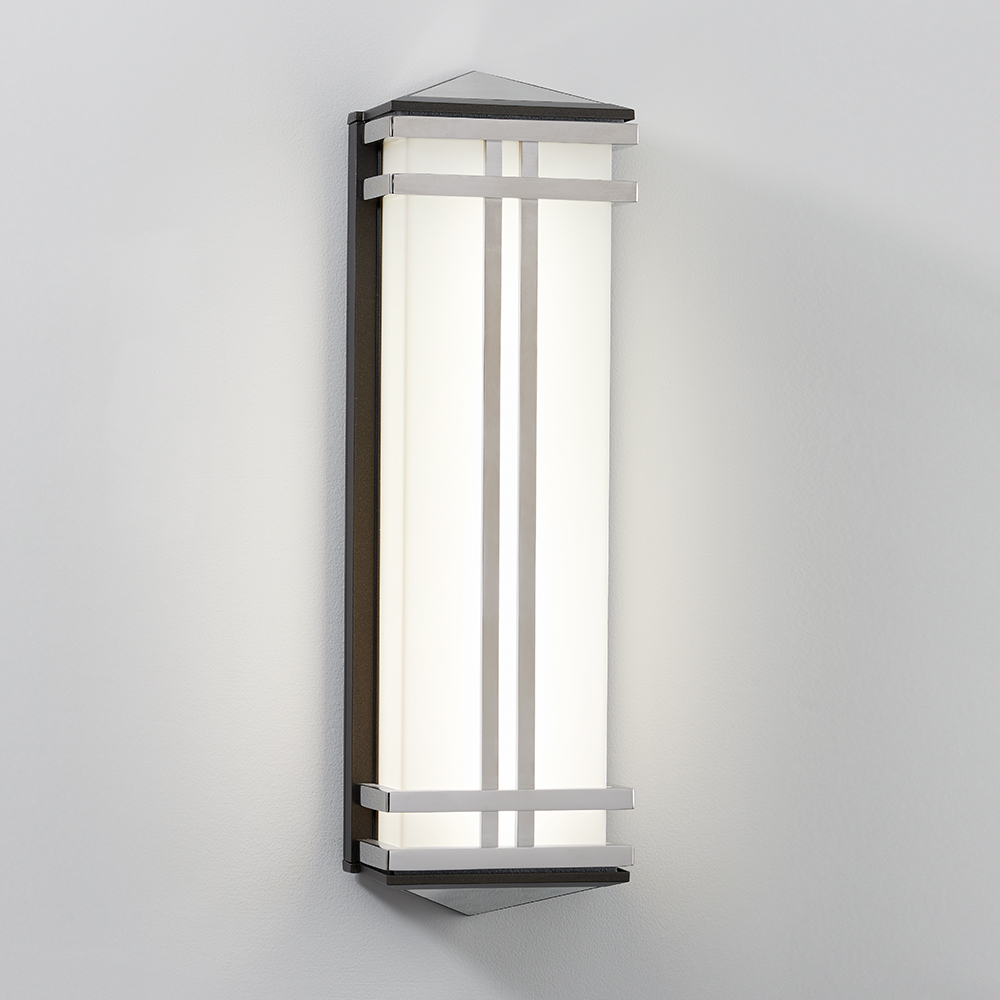 A classic architectural sconce with metallic frame and pointed top accent