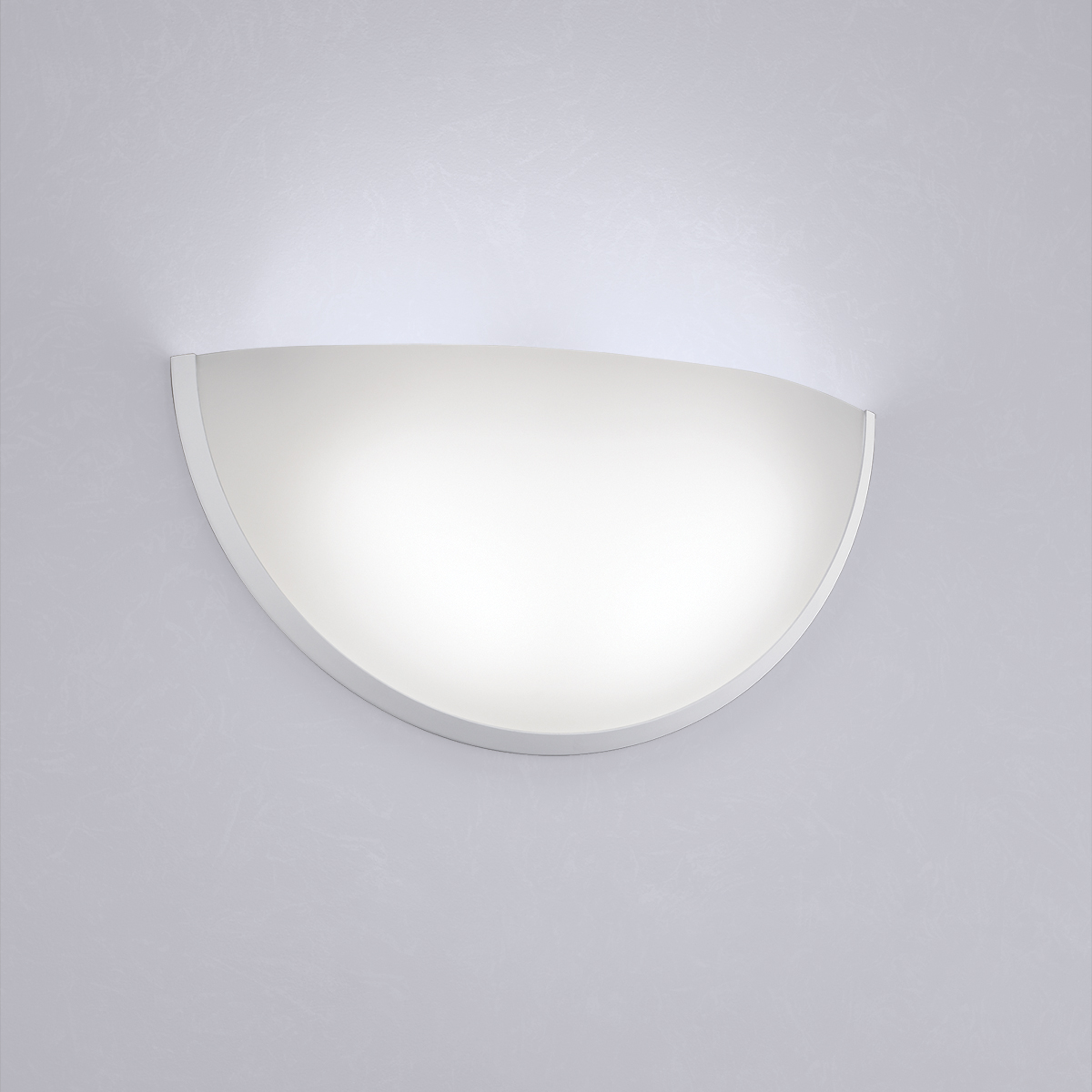 A clean, luminous quarter sphere wall sconce with minimal trim