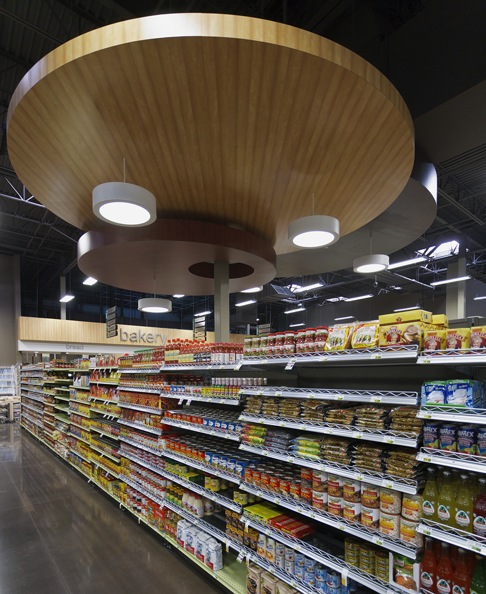 Omnience fixtures are good for retail lighting designs, seen here above the shelves of a modern grocery store.